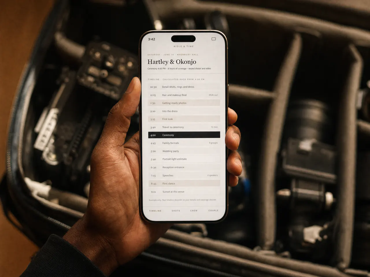 Hands holding a phone showing the coverage timeline, over an open camera case.