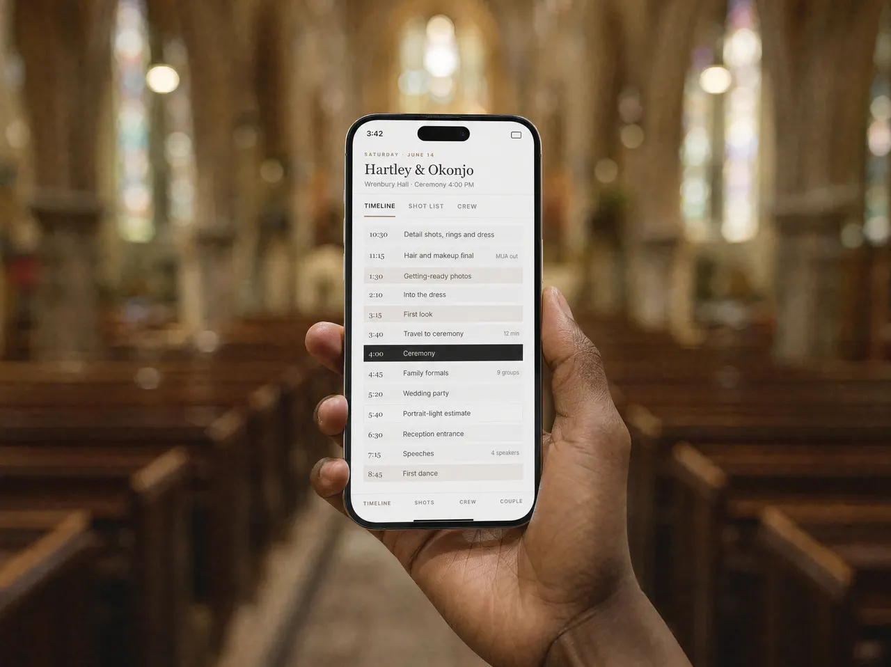 Hands holding a phone showing the coverage timeline, standing in a church aisle.