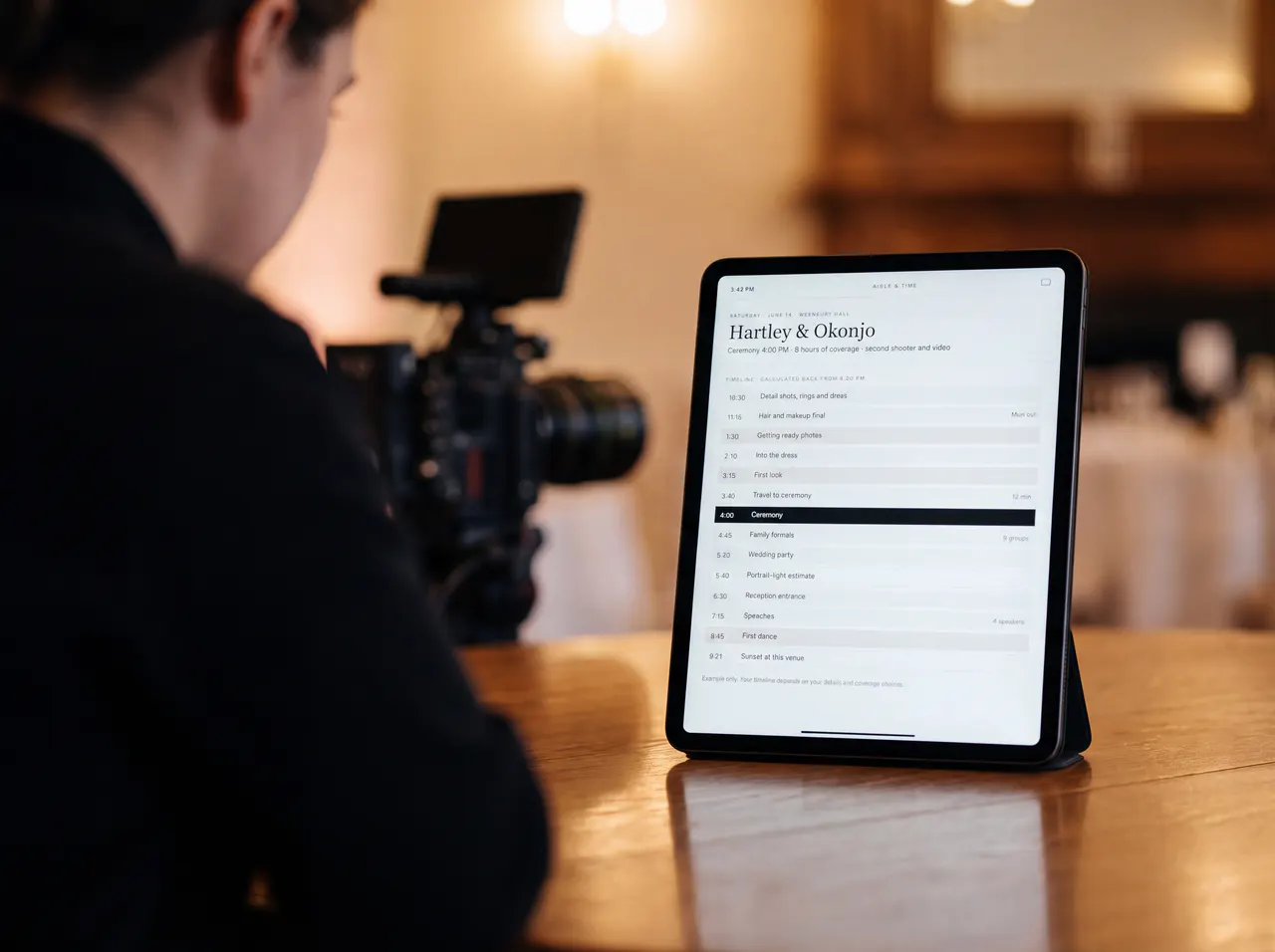 A photographer seen from behind, with a tablet showing the coverage timeline.